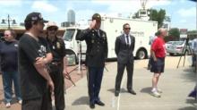 Mourners offer their condolences at a memorial set up in front of the Dallas Police Headquarters.